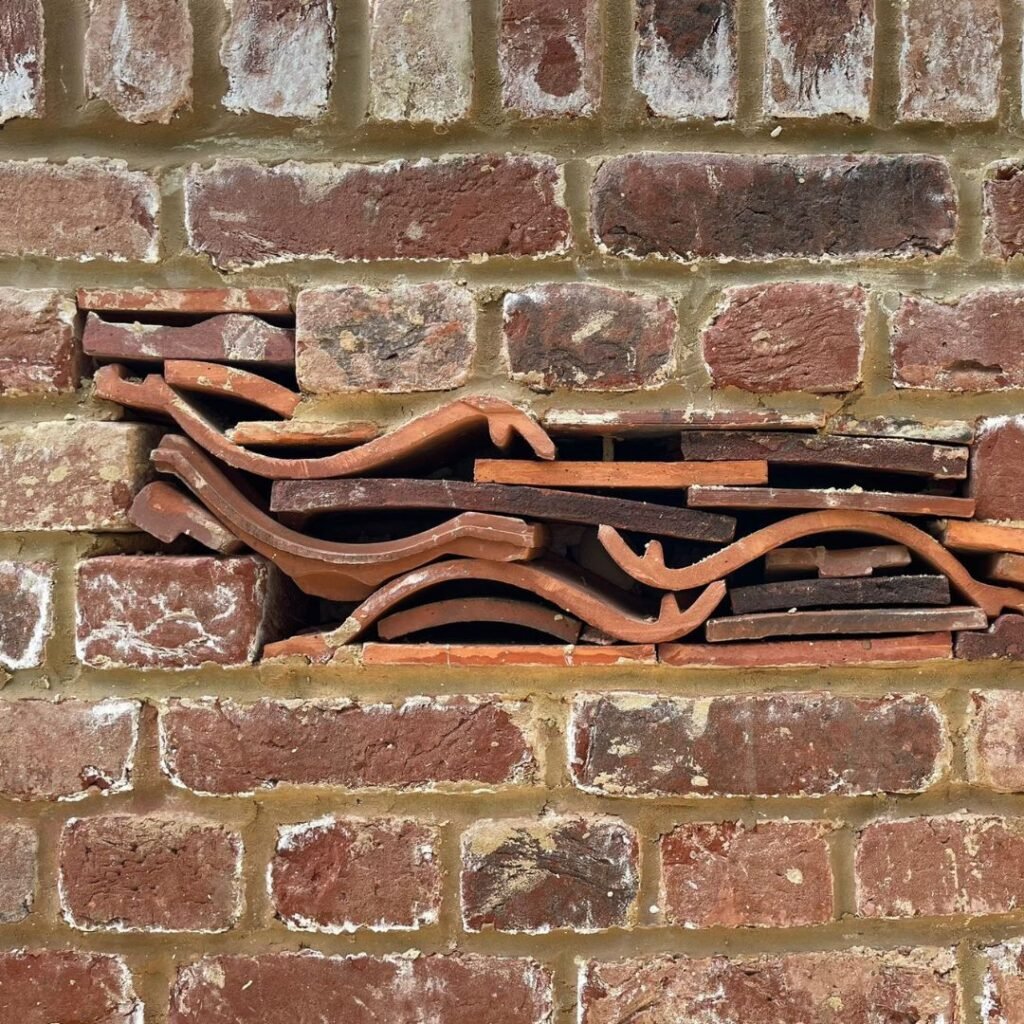 Image of wapan tiling in a brick wall - one style of bug hotel that can be landscaped into your garden.