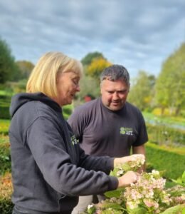 Sam and Danny doing gardening together.